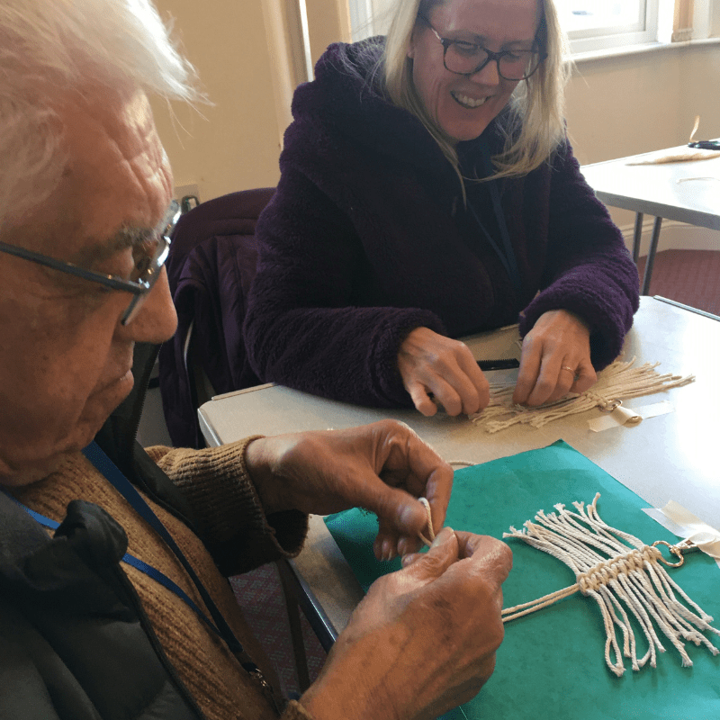 A gentleman sat down at the table with carer crafting